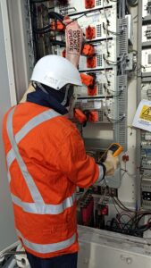 Technician completing live BESS battery BMS cable Insulation Resistance testing